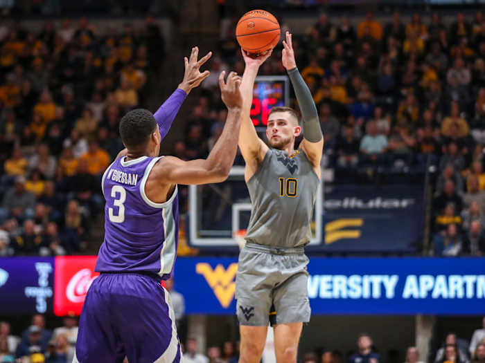 West Virginia guard Erik Stevenson shoots a three-pointer over Kansas State forward David N’Guessan.